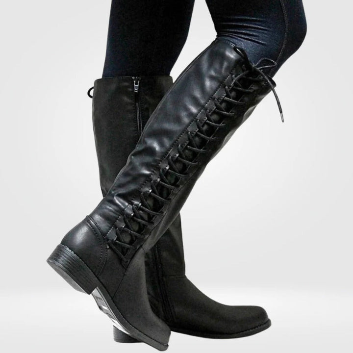 Black lace-up knee-high boots with side lacing, worn