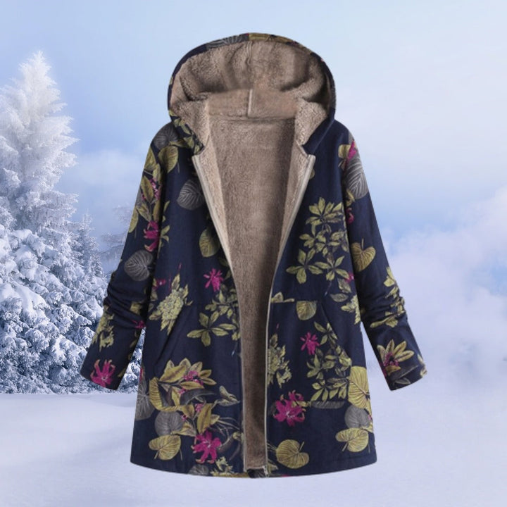 Reversible hooded winter coat in navy floral, on a hanger, open to show the fleece lining