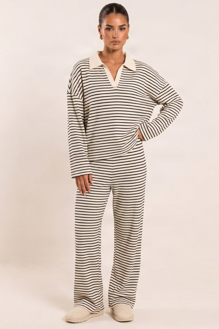 Striped knitted co-ord with collared jumper and wide-leg trousers in cream with dark stripes, worn, front view