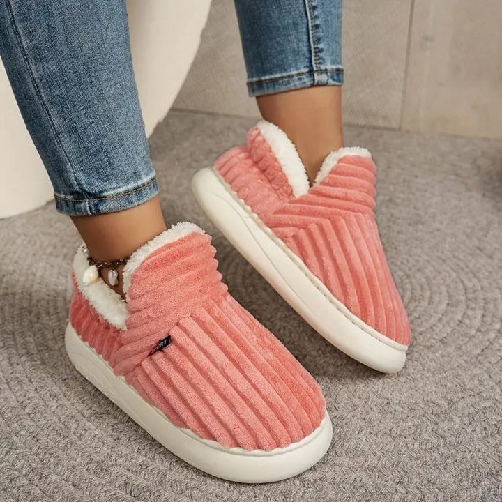 Coral pink closed-back slippers, worn