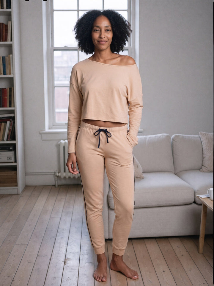 Model in the tan bamboo lounge set with an off-shoulder crop top in a London flat