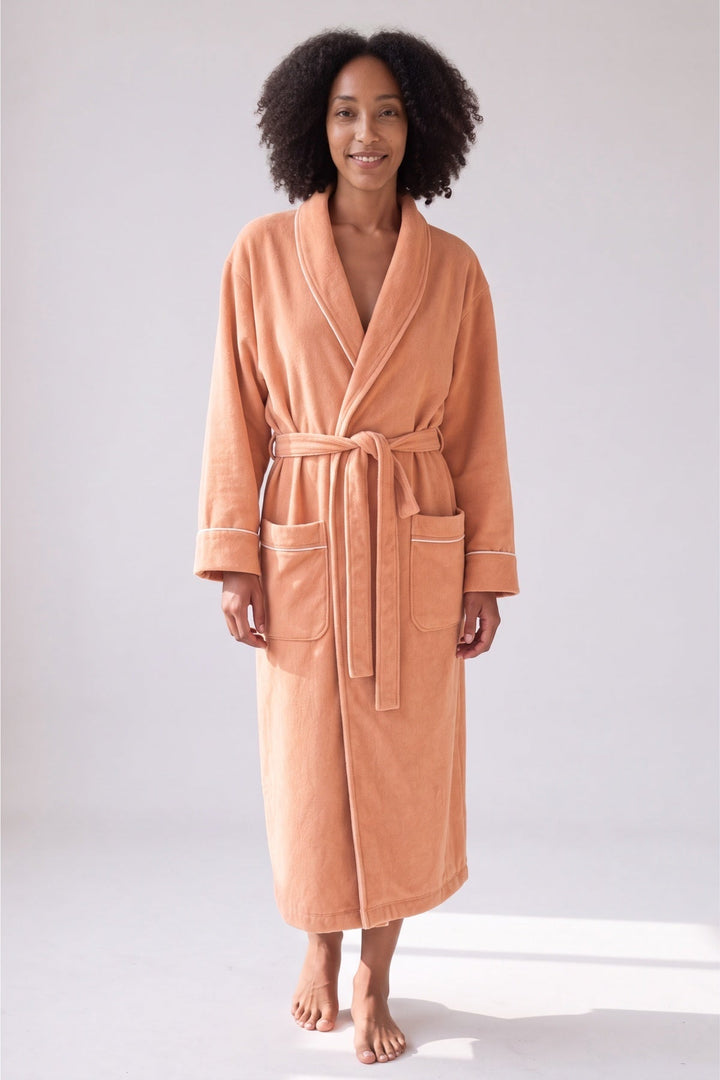Long apricot cotton towelling dressing gown with white piping, worn, front view