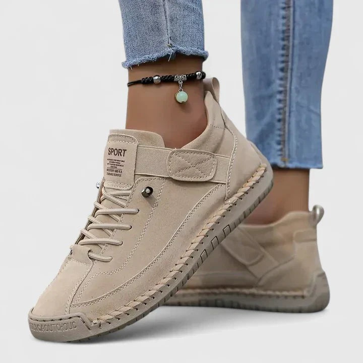 Beige orthopaedic trainers with velcro strap, worn with jeans