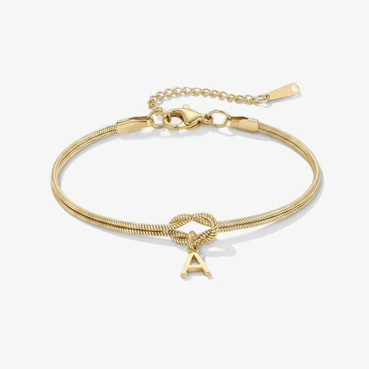Gold initial bracelet with knot and letter A charm