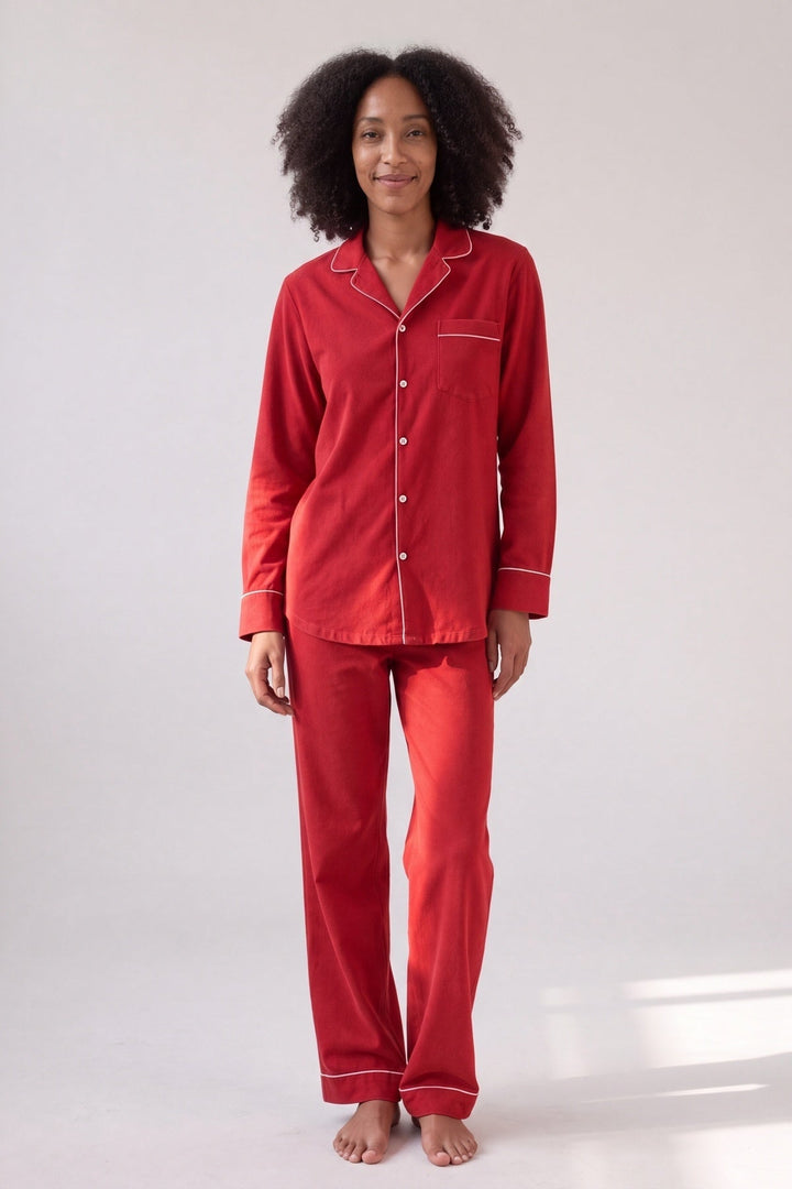Red bamboo button-up pyjamas with white piping, worn, front view