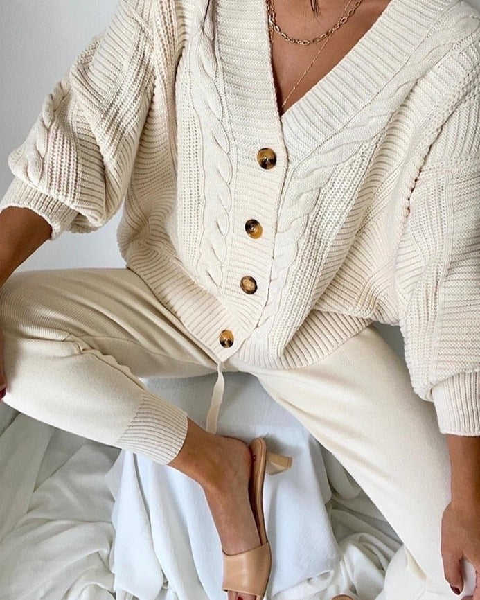 Cream cable knit cardigan and joggers set, worn seated