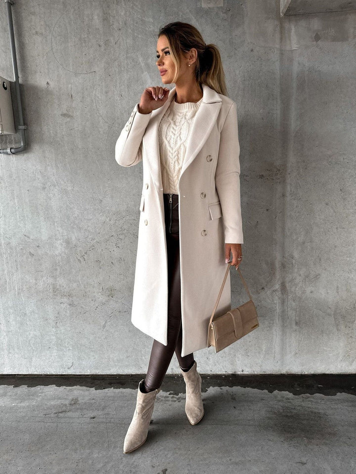 Woman in a long cream double-breasted coat
