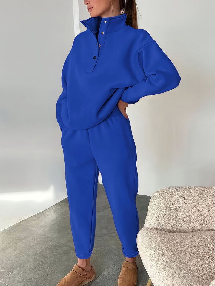 Royal blue tracksuit with button stand collar, full-length view