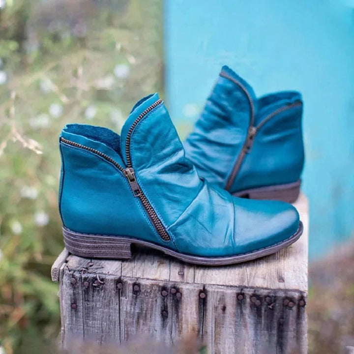 Blue ruched ankle boots with diagonal side zip and low heel