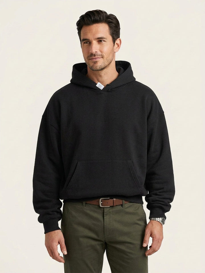 Men's fleece-lined pullover hoodie in black, worn, front view
