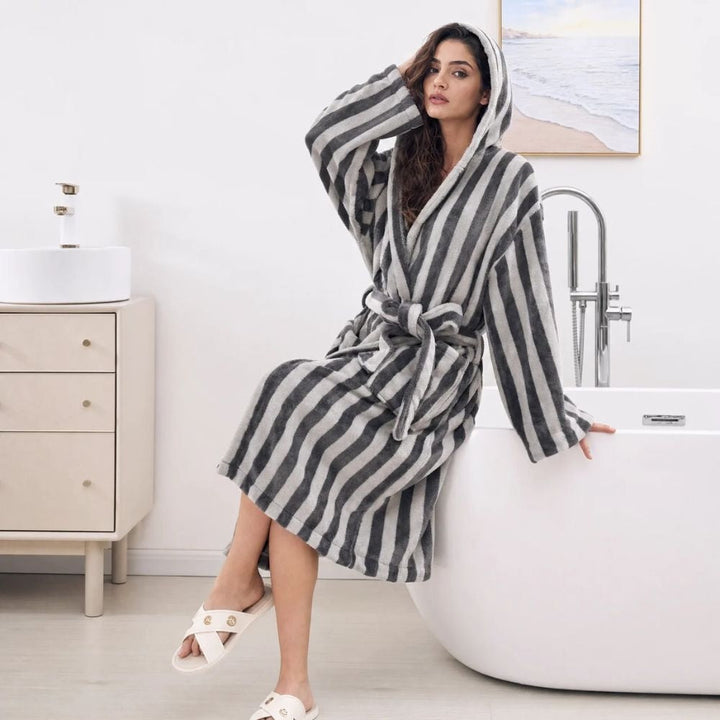 Grey striped hooded dressing gown, sitting on the edge of a bathtub