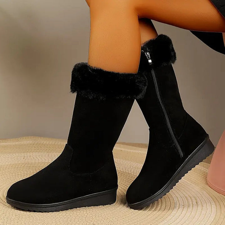 Pair of black suede-look boots with faux fur cuff and side zip