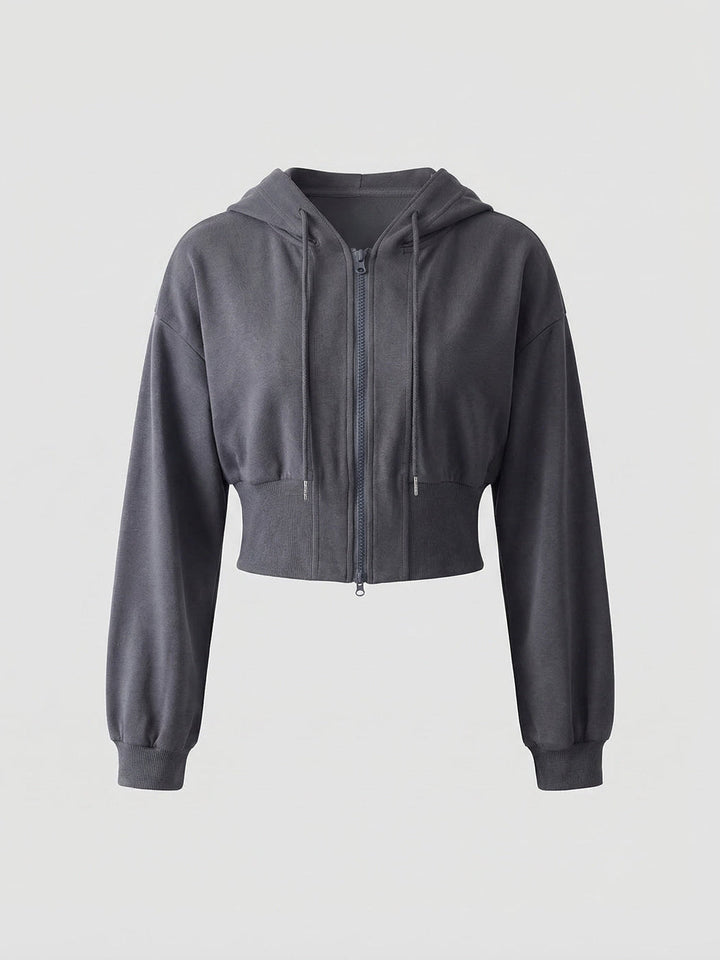 Dark grey cropped zip-up hoodie with a hood and wide ribbed waistband, front-view product shot | Grace Aura