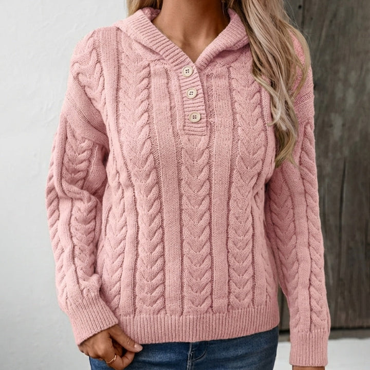 Woman wearing a pink cable-knit hoodie with a button placket, with jeans | Grace Aura