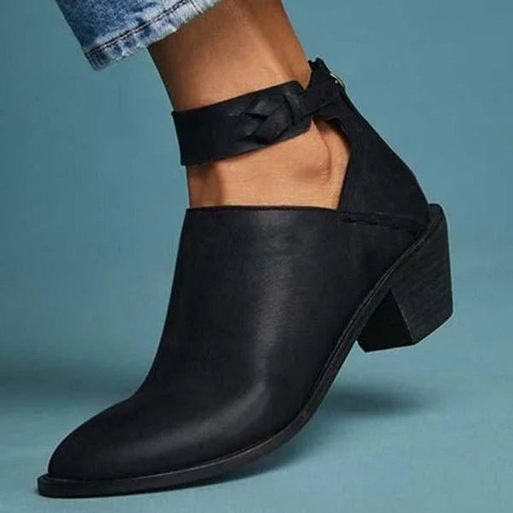 Black cut-out ankle boot with braided ankle strap, worn