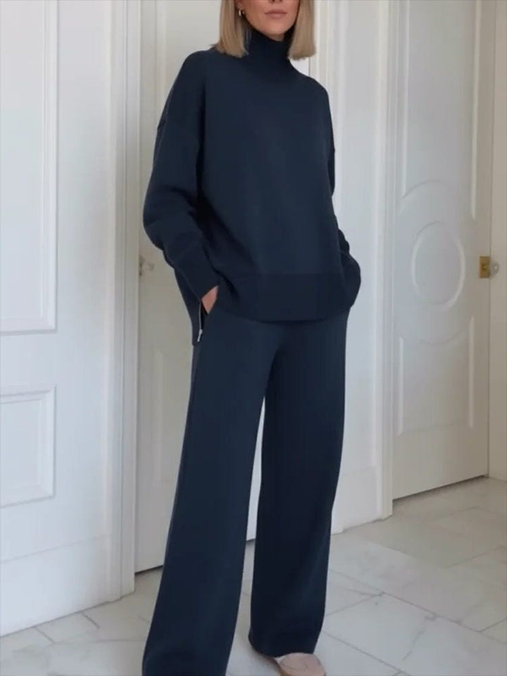Navy knitted roll-neck co-ord set, front view, hand in the pocket