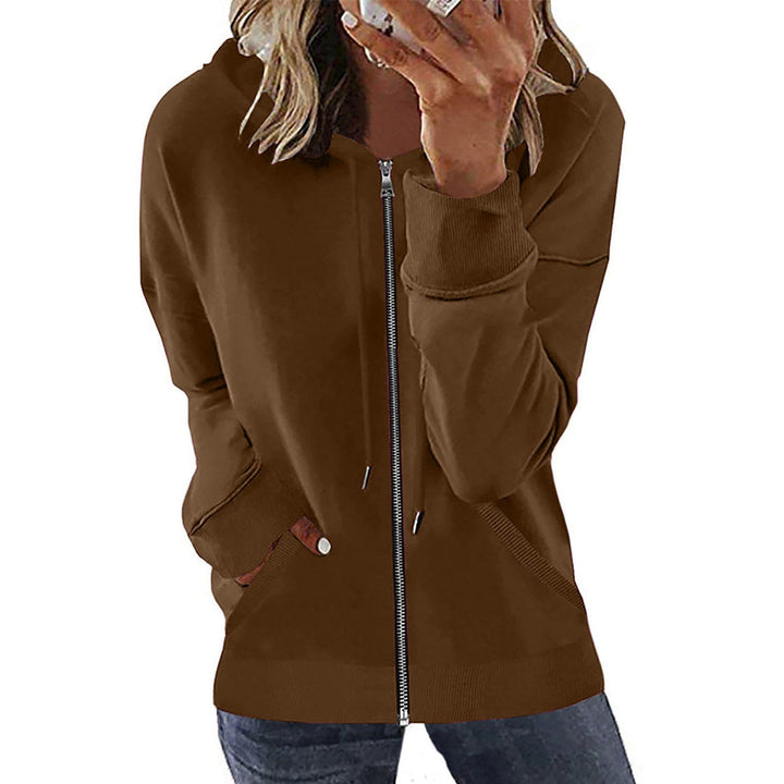 Woman wearing a brown hooded jacket with dropped shoulders and ribbed cuffs | Grace Aura