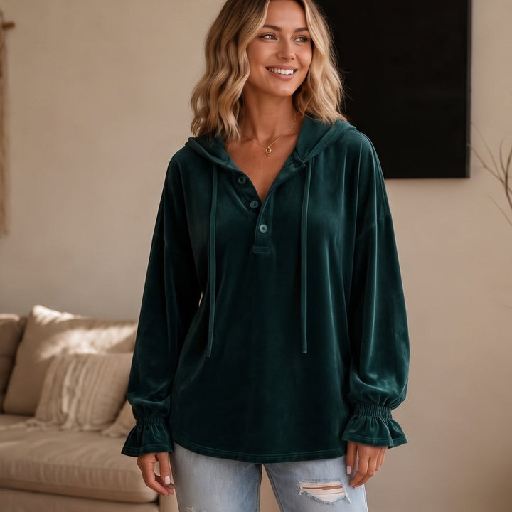 Woman wearing a dark green velour-look hoodie with a short button placket, front view | Grace Aura