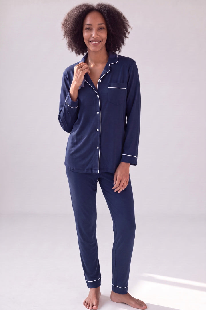 Midnight navy bamboo pyjamas with white piping, button-up shirt and slim trousers, worn, front view