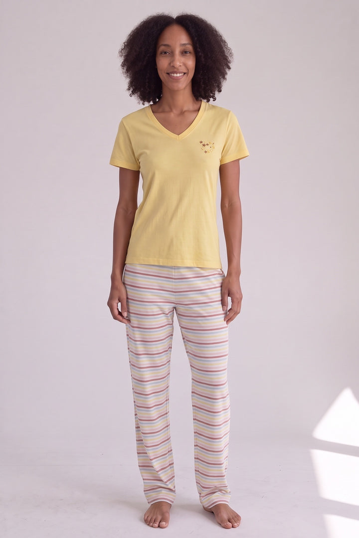 Yellow short-sleeved cotton pyjama top with striped trousers, worn, front view