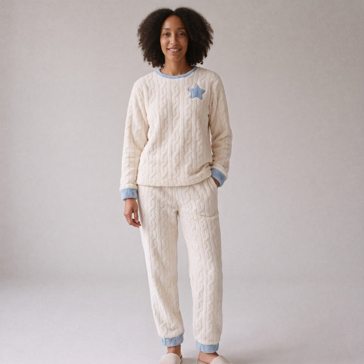 Ivory plush fleece pyjamas with a light blue star and light blue trim, worn, front view