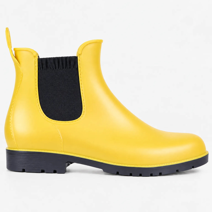 A single yellow Chelsea style rain ankle boot with black elastic side gusset, rear pull tab and black lug sole, shown in side profile on a plain white background.