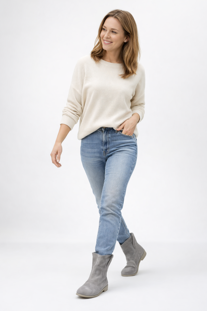 Gray suede ankle boots worn by woman with jeans and sweater | Grace Aura