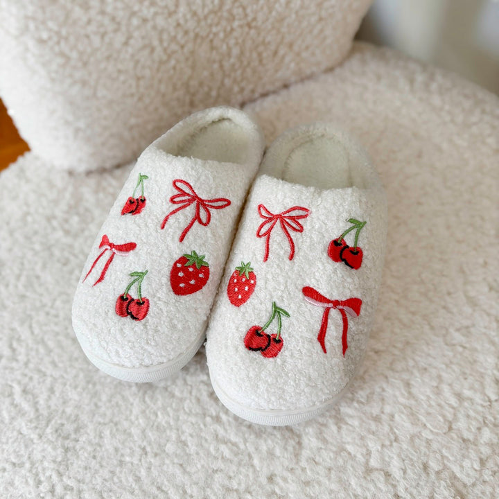 White fuzzy slippers with embroidered cherries, strawberries, and red bows design | Grace Aura