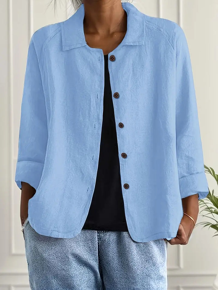 Light blue collared button-up blouse worn by woman, three-quarter sleeves visible | Grace Aura