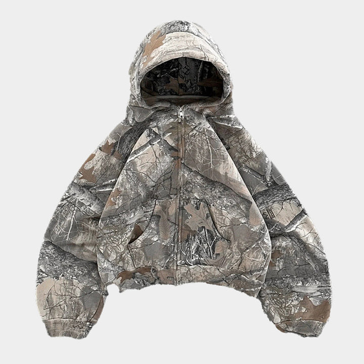 Camouflage zip-up hoodie with hood, laid flat, tree-pattern print fabric | Grace Aura