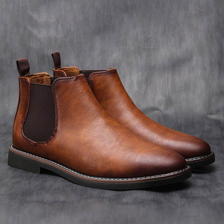 Brown leather Chelsea boots with elastic side panels, shown as a pair standing | Grace Aura