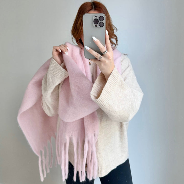 Woman wearing pink chunky knit fringed scarf over beige cardigan | Grace Aura
