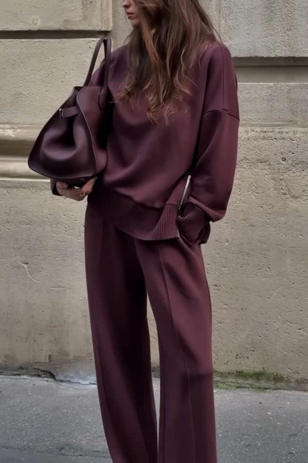 Woman wearing burgundy oversized pullover and matching wide-leg trousers outdoors | Grace Aura