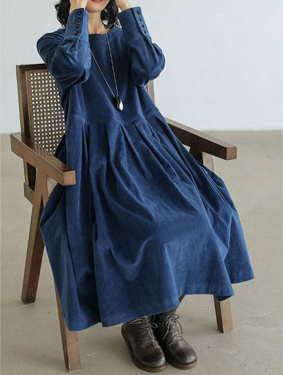 Navy blue corduroy oversized long sleeve midi dress worn by seated woman | Grace Aura