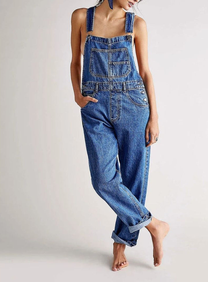 Woman wearing blue denim overalls with rolled cuffs, cropped sleeveless top | Grace Aura