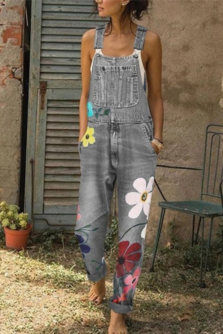 Woman wearing gray denim overalls with colorful floral print, worn outdoors casually | Grace Aura