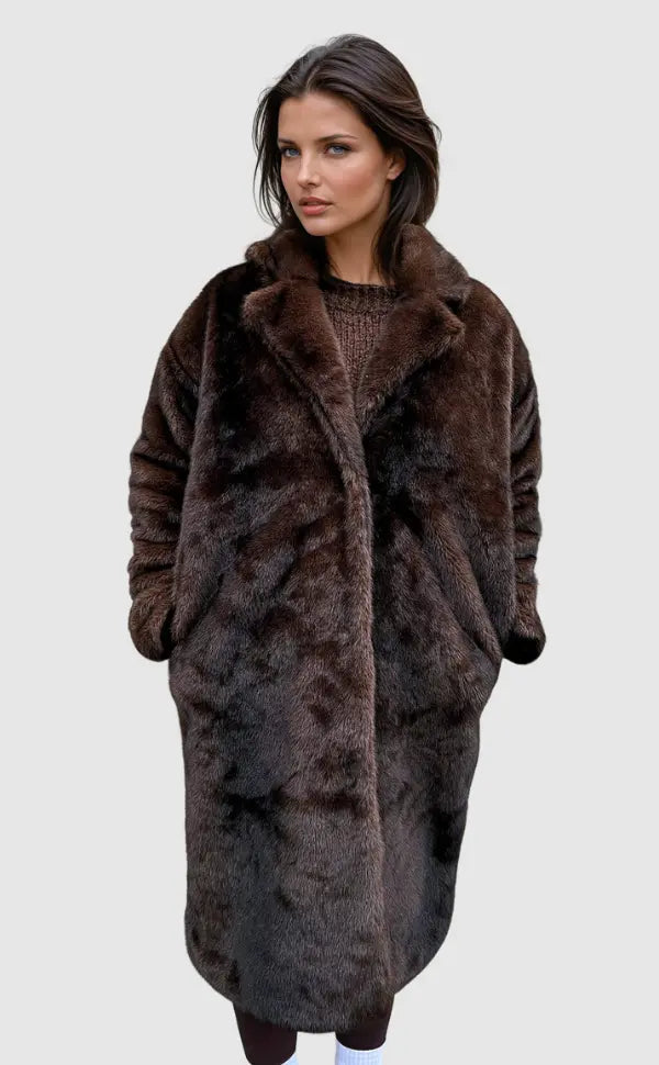 Woman wearing long brown faux fur coat over knit sweater outdoors | Grace Aura