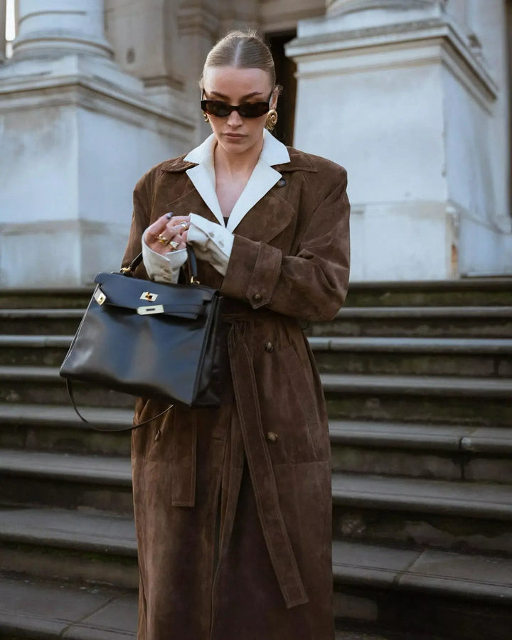 Brown faux suede double-breasted trench coat worn by woman on stairs | Grace Aura
