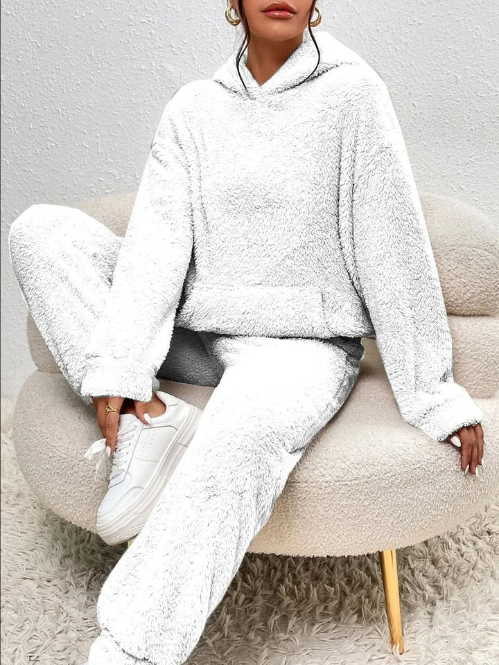 White fleece hoodie and joggers set worn by seated woman | Grace Aura