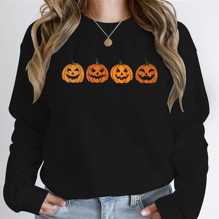 Black sweatshirt with four jack-o-lantern pumpkins, worn by woman | Grace Aura