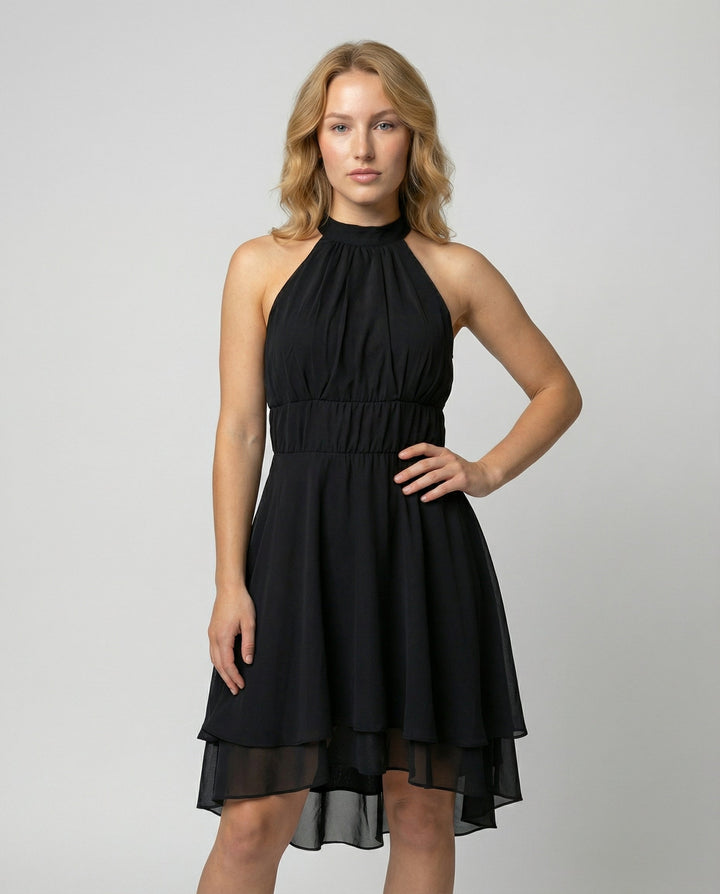 Black chiffon halterneck dress with layered hem, worn by a woman | Grace Aura