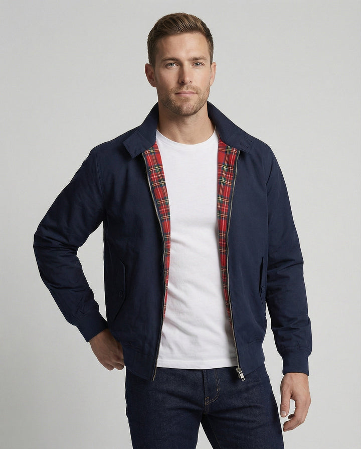 Man wearing navy Harrington jacket with red tartan lining, open front | Grace Aura
