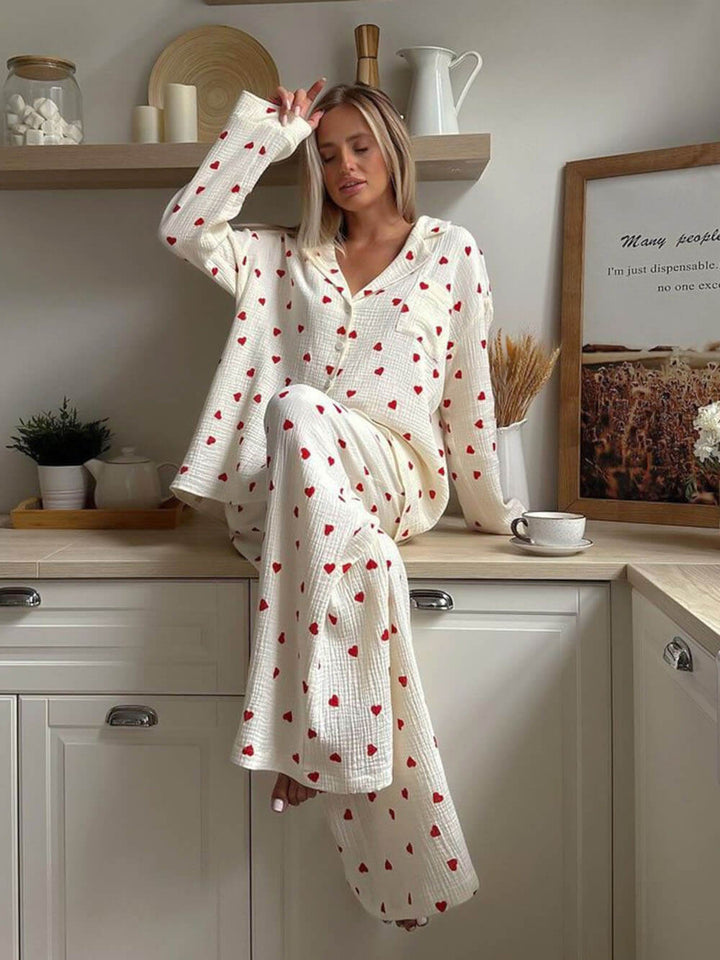 Woman wearing cream heart print pyjama set, sitting on kitchen counter | Grace Aura