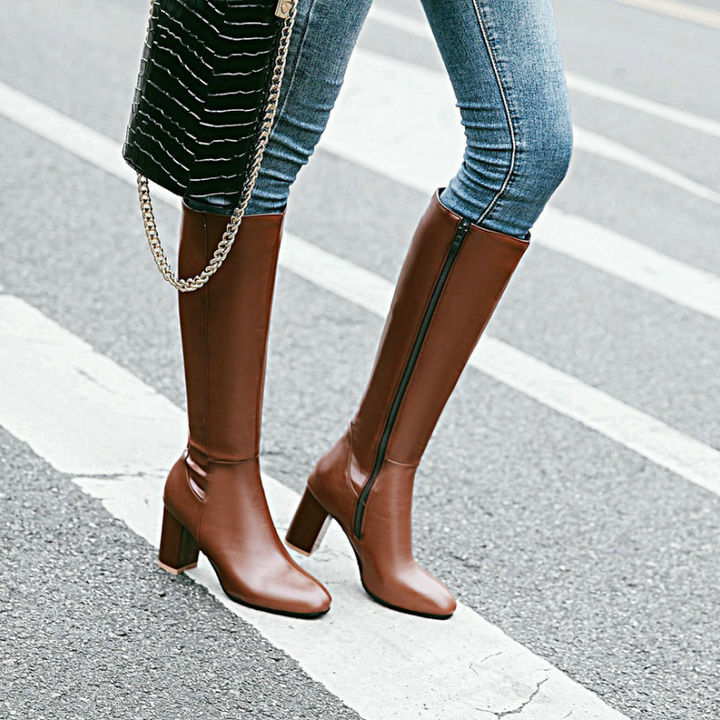 Brown leather knee-high boots with block heels, worn by person walking | Grace Aura