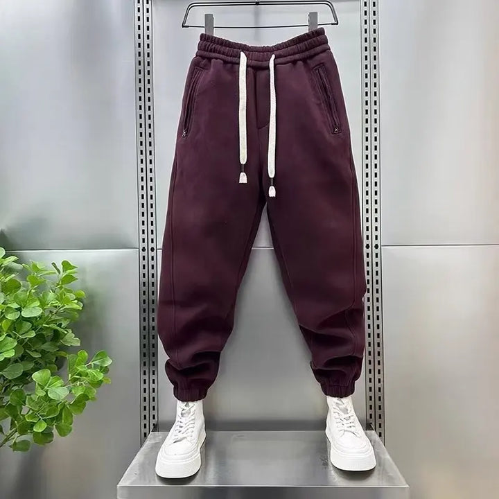 Dark maroon fleece jogger sweatpants with drawstring, displayed on hanging mannequin form | Grace Aura