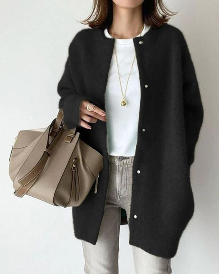 Black knit button-up cardigan worn by woman with tote bag | Grace Aura