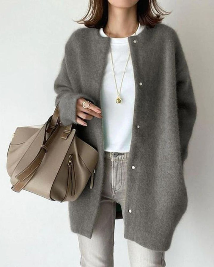 Woman wearing gray oversized button-up knit cardigan with white top and jeans | Grace Aura