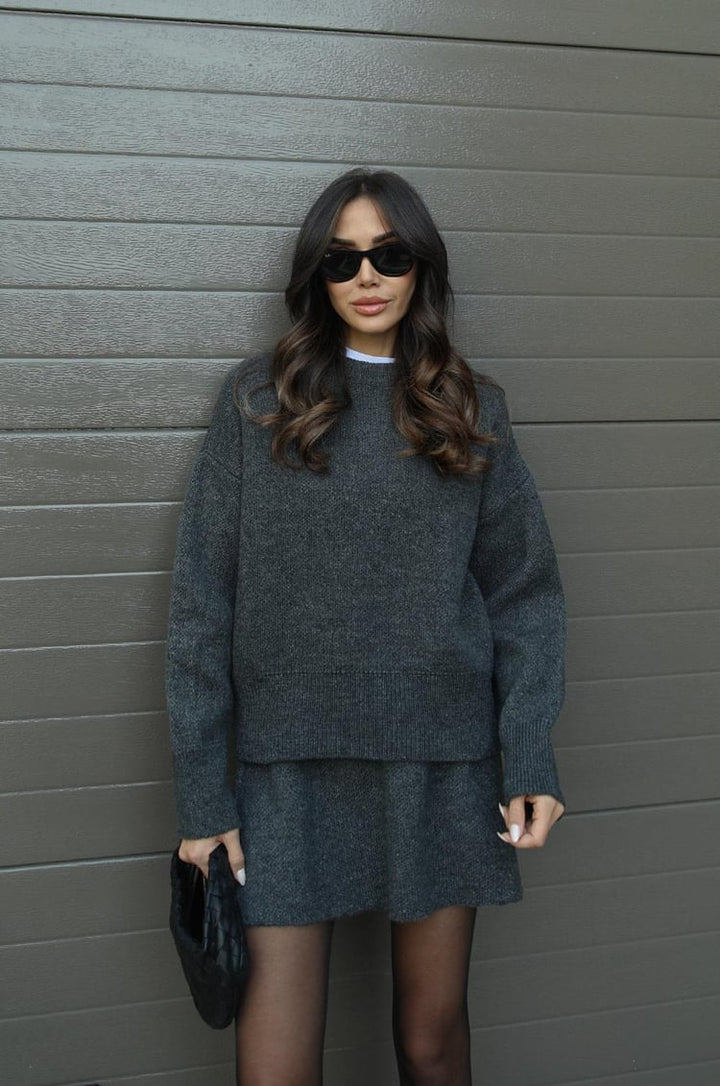 Woman wearing charcoal grey knit sweater and mini skirt set outdoors | Grace Aura