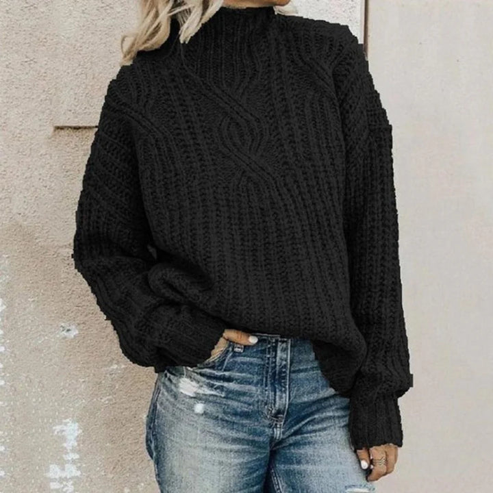 Black chunky cable knit turtleneck sweater worn by woman with jeans | Grace Aura