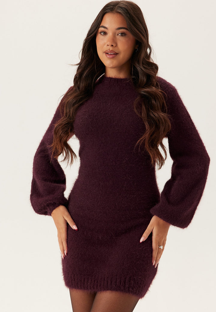 Woman wearing burgundy fluffy knit mini dress with long balloon sleeves | Grace Aura
